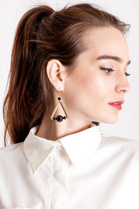 Triangle earrings made of hand-cut, hand polished and galvanized brass, onyx and gold plated sterling silver.
