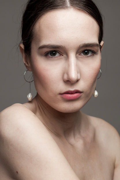 Slightly different white pearl earrings