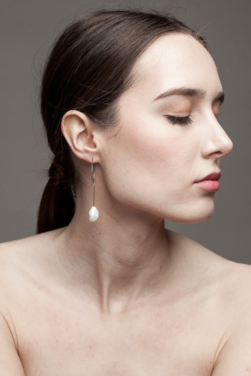 Slightly different white pearl earrings
