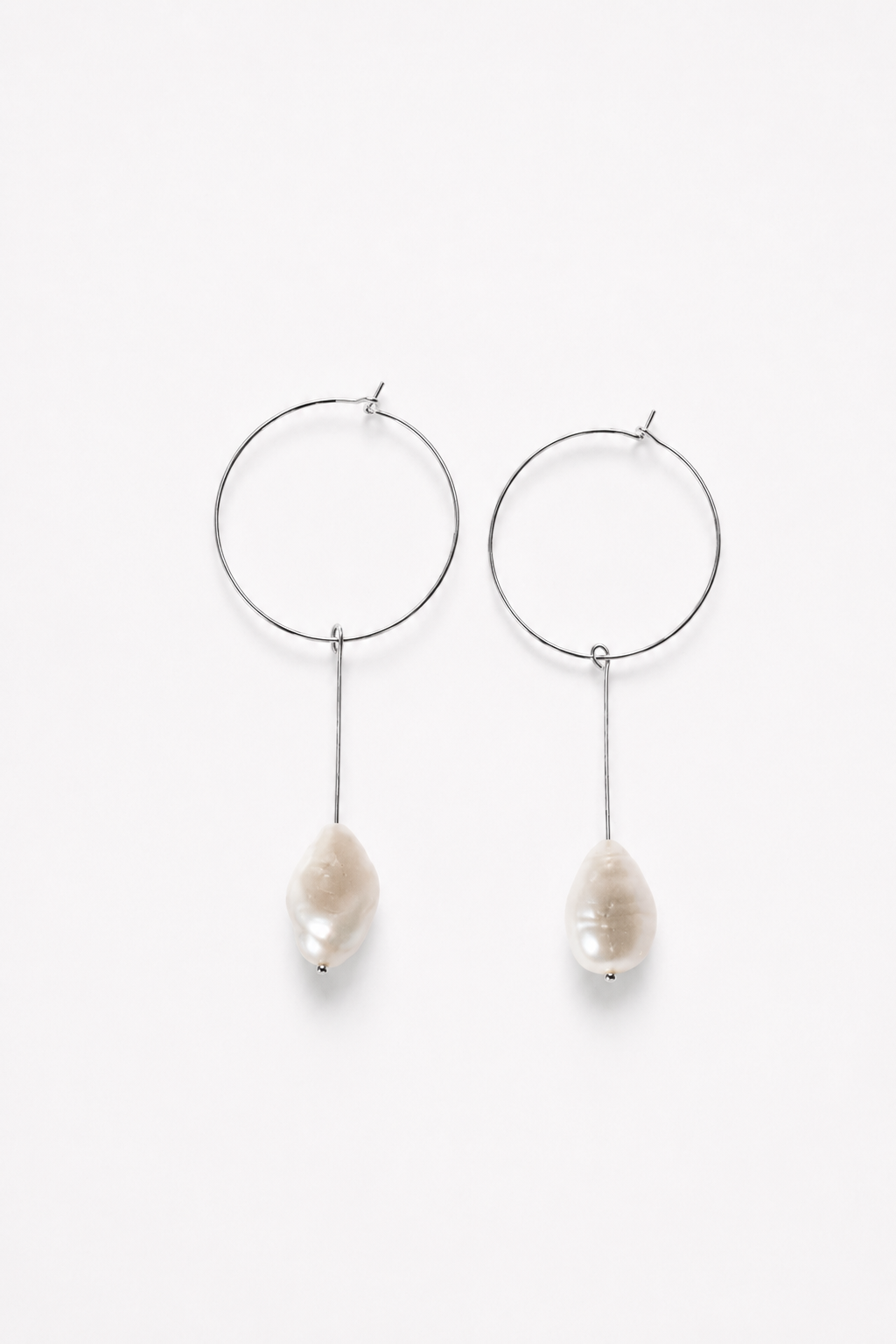 Slightly different white pearl earrings