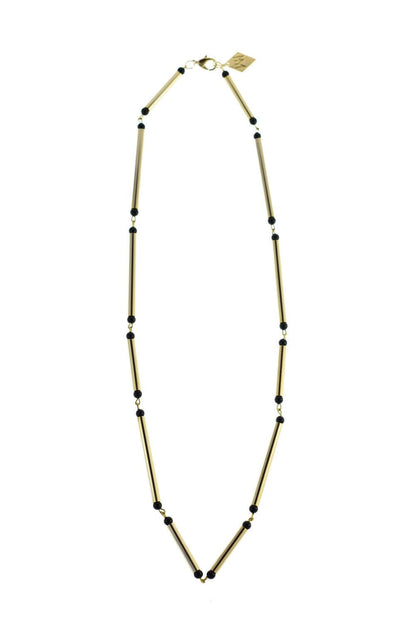 Hidden lines gold edition made of hand-cut, hand polished and galvanized brass featuring black onyx.
