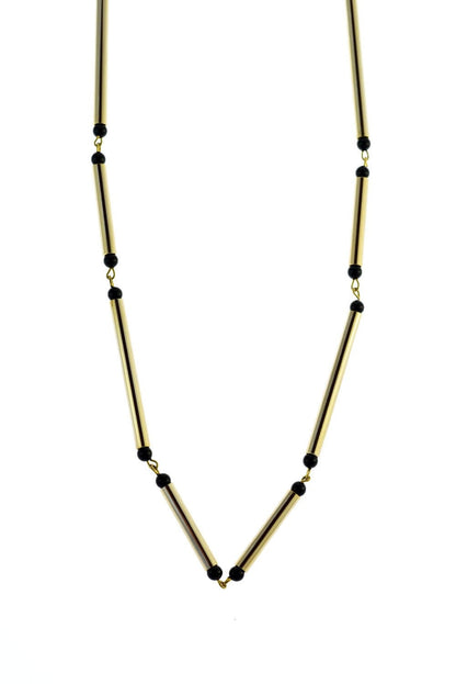 Hidden lines gold edition made of hand-cut, hand polished and galvanized brass featuring black onyx.