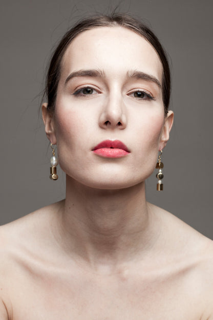 This mismatched earrings are made of hand cut and 24K gold-plated brass, freshwater pearls and gold-plated sterling silver.