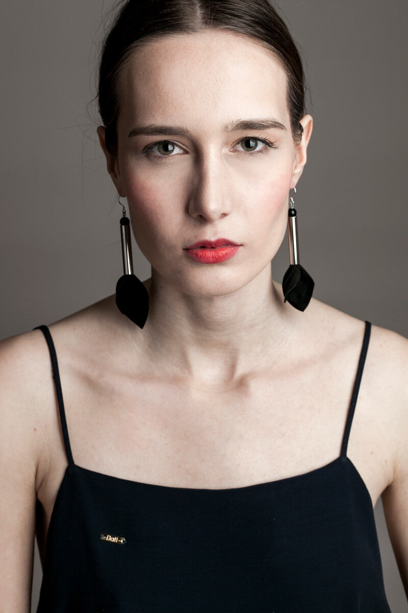 Earrings made of hand-cut leather, galvanized brass, onyx and sterling silver. 
